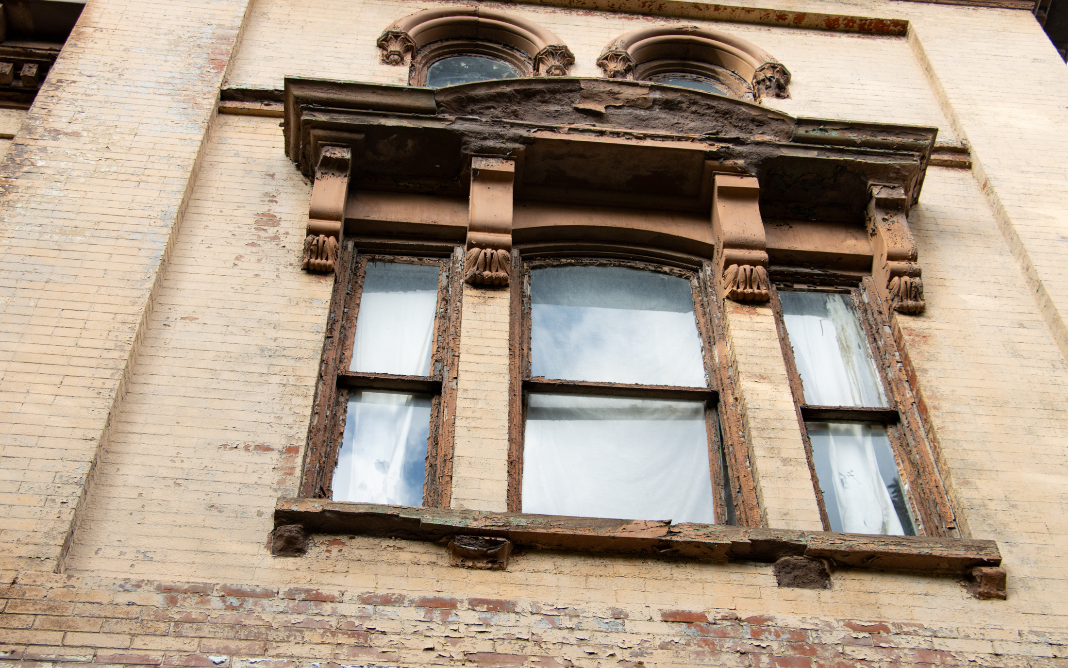 window detail showing spalling brownstone