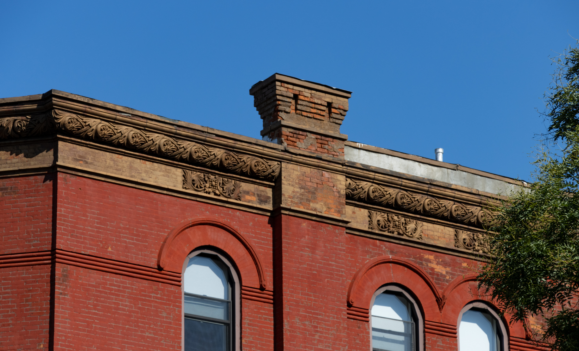 cornice with decorative details on a brick building