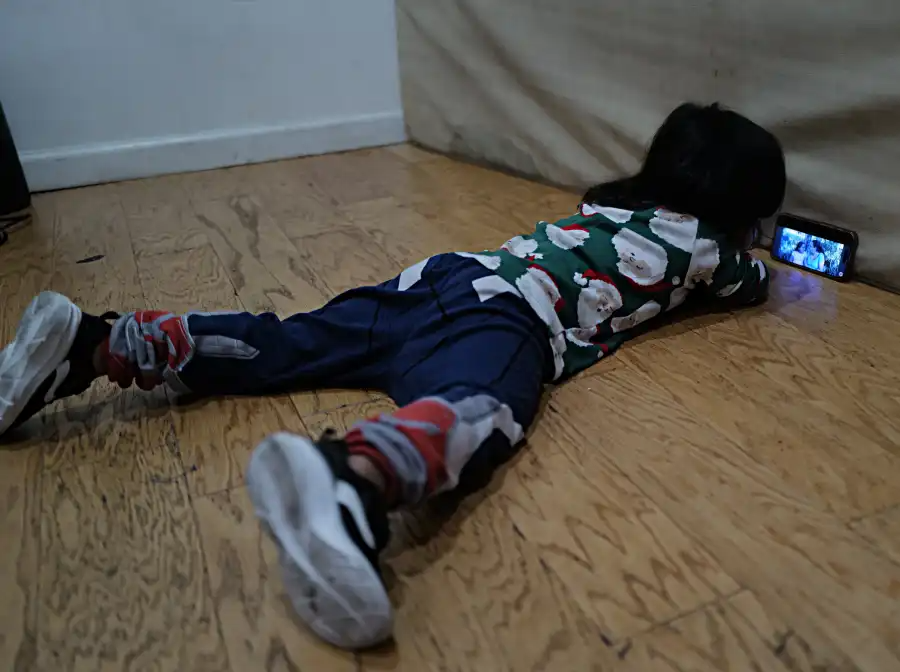 Emmanuel plays with a cellphone.