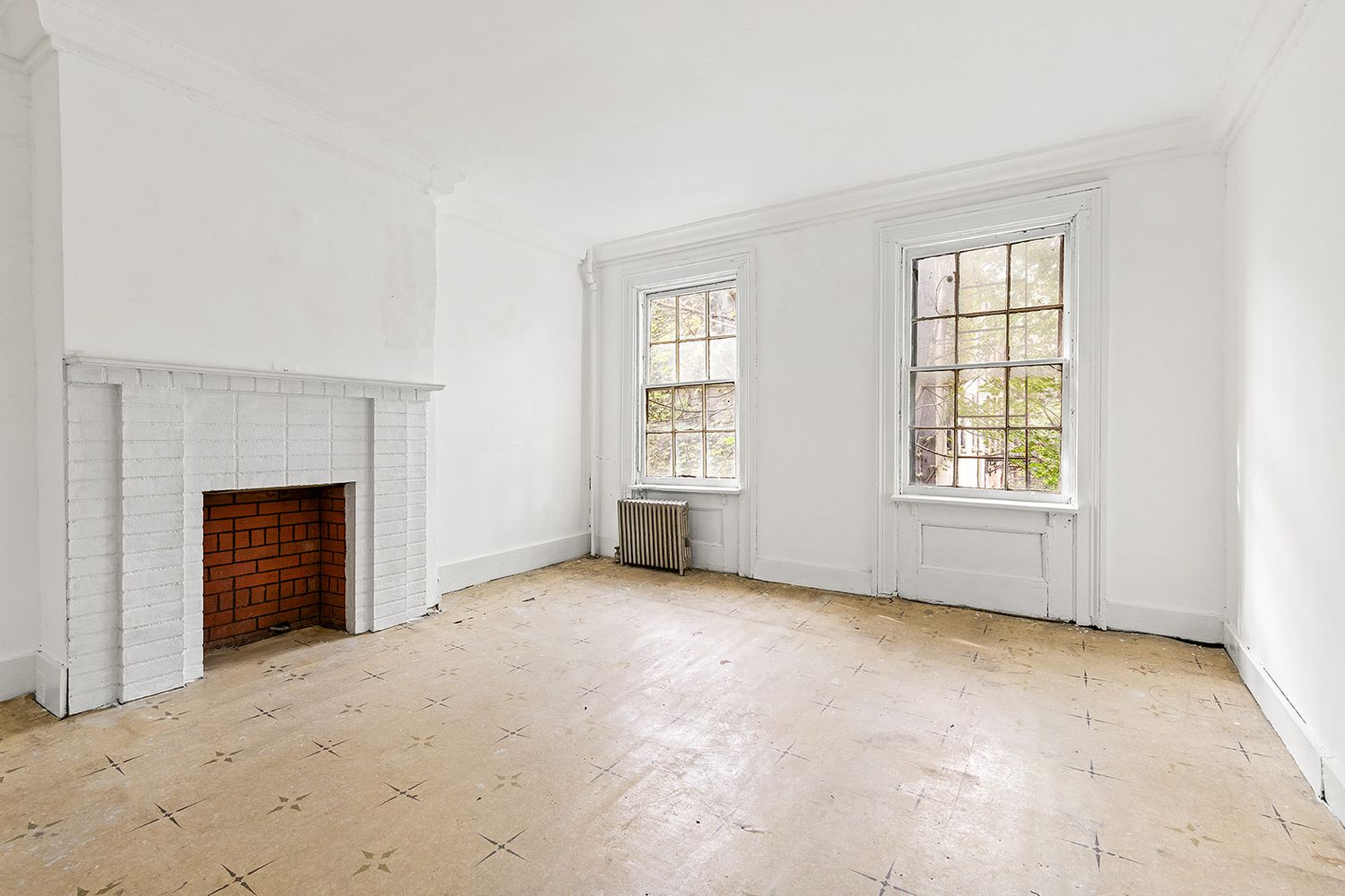 bedroom with linoleum floor and brick mantel
