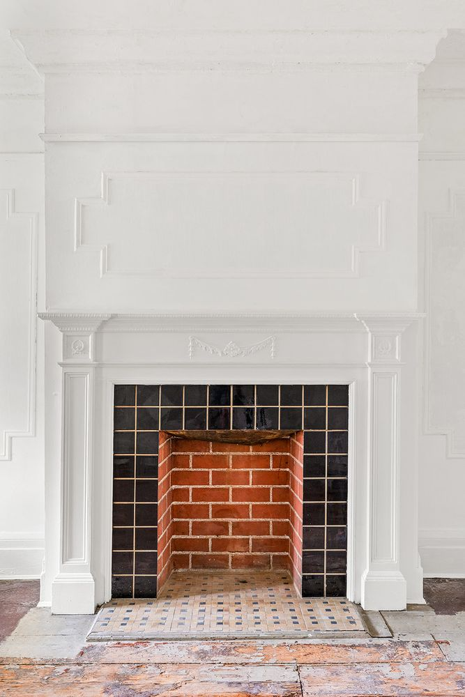 white painted mantel with later tile surround
