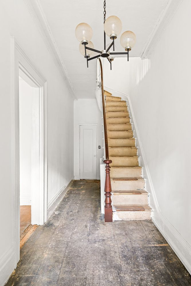 entry hall with newel post and wide plank floorboards