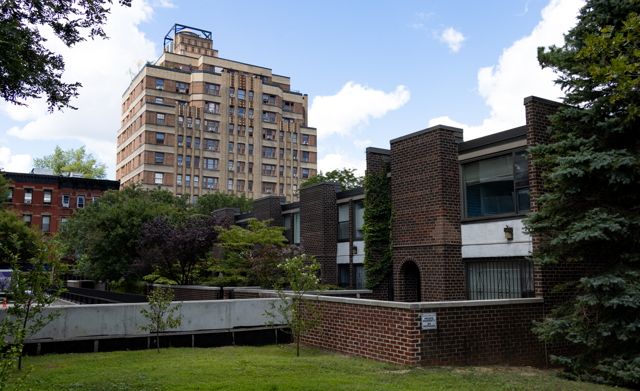 low scale co-op complex with a tall building behind