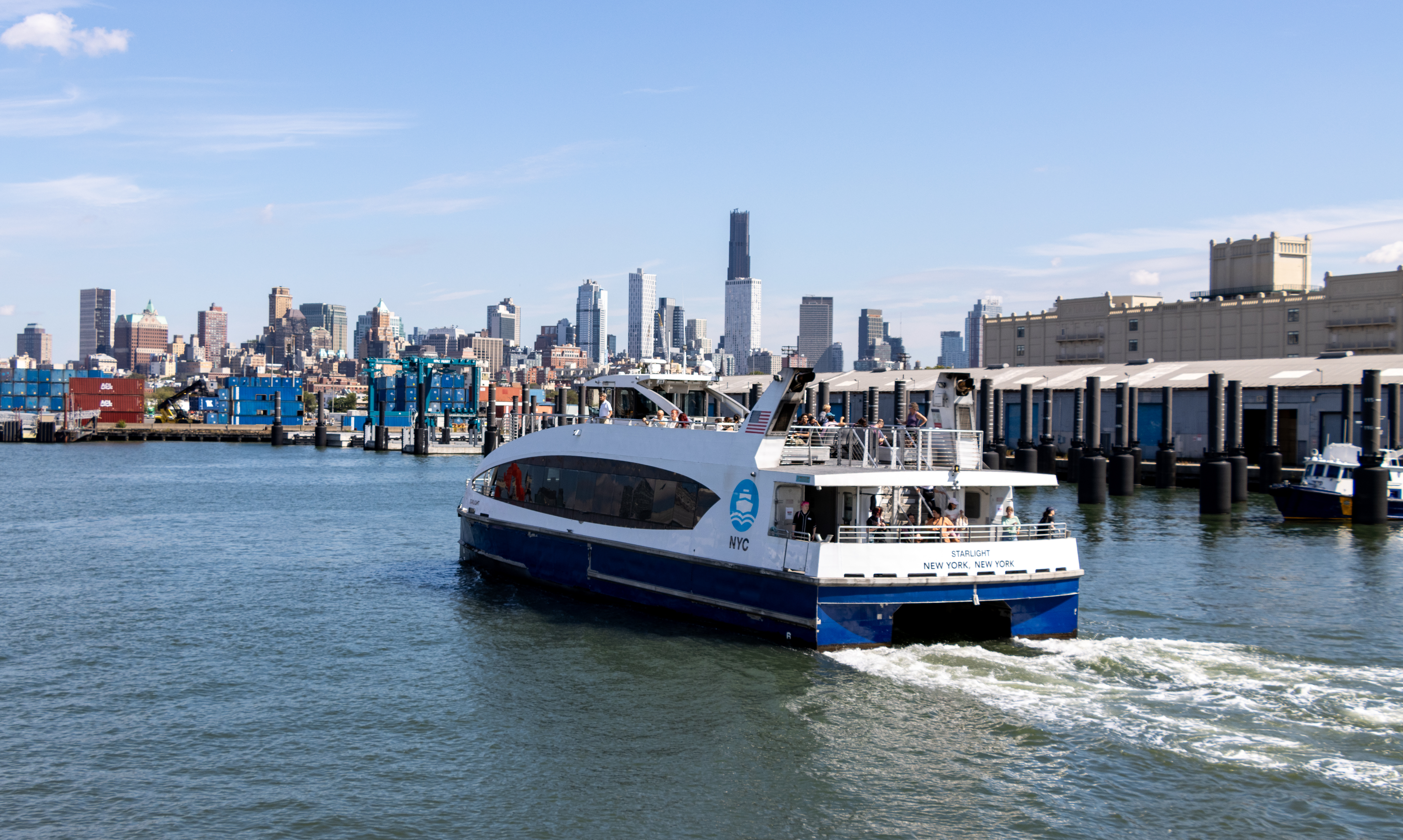 a ferry boat and the brooklyn skyline