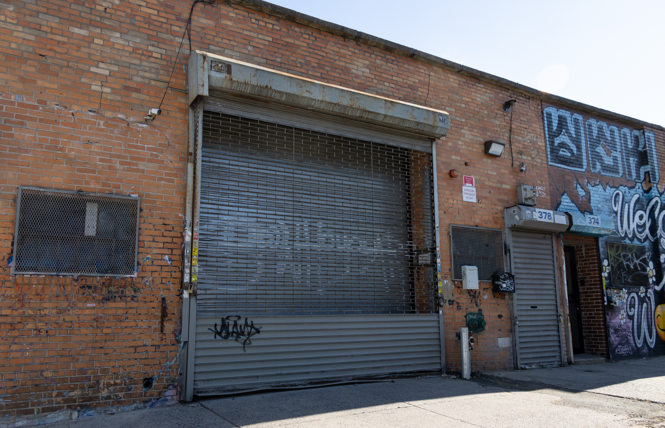 lowscale brick industrial building with no. 378 on roll up gate