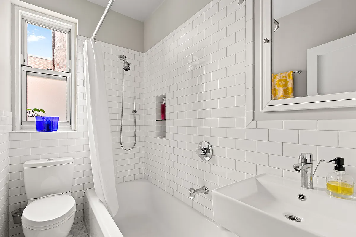 bathroom with white subway tile and white fixtures
