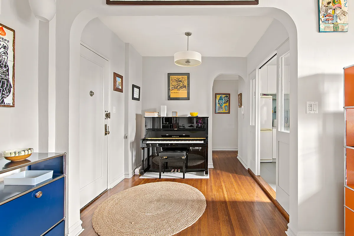 foyer with arched doorways, room for a piano
