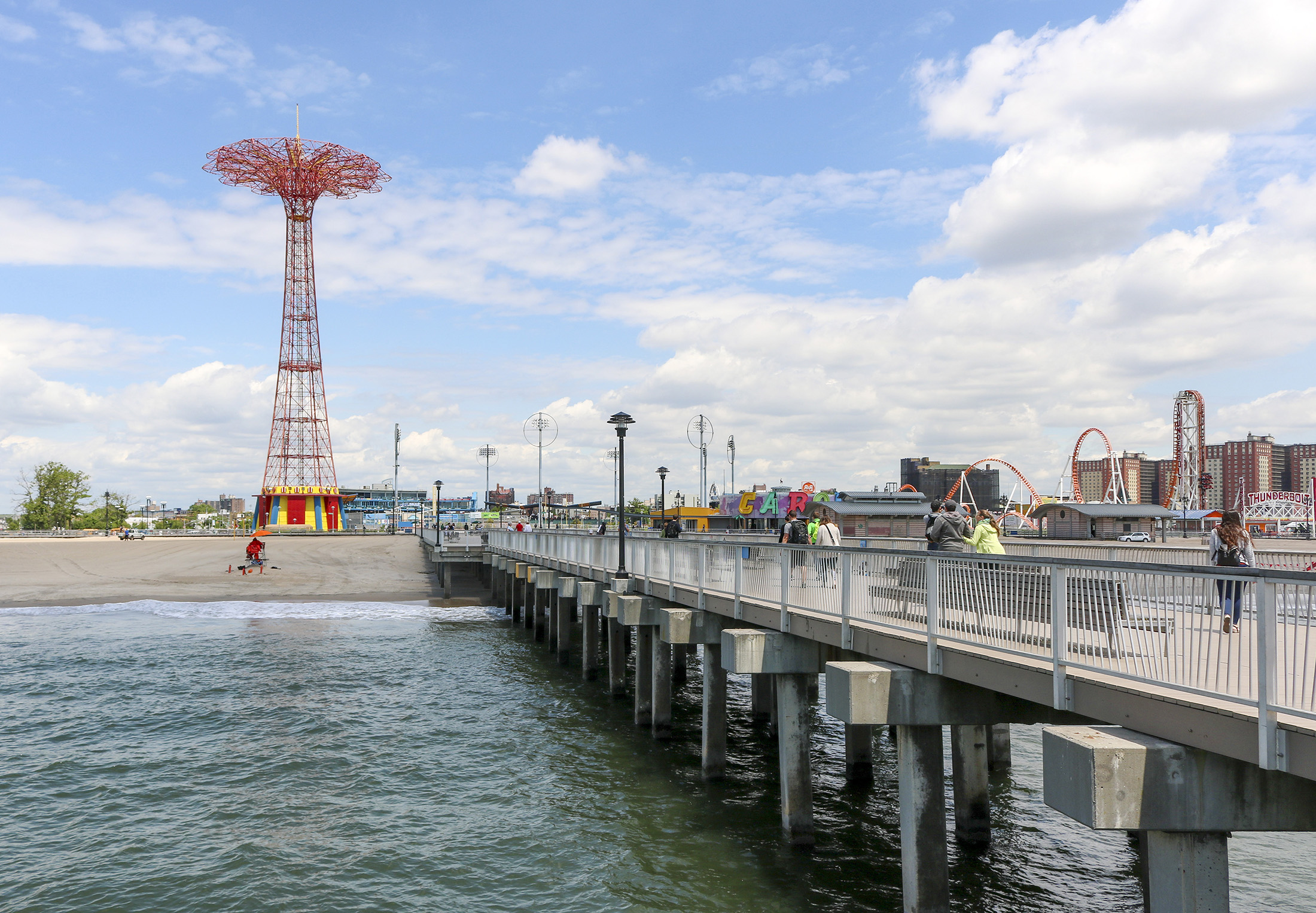 pier with beach and the parachute jump in the background