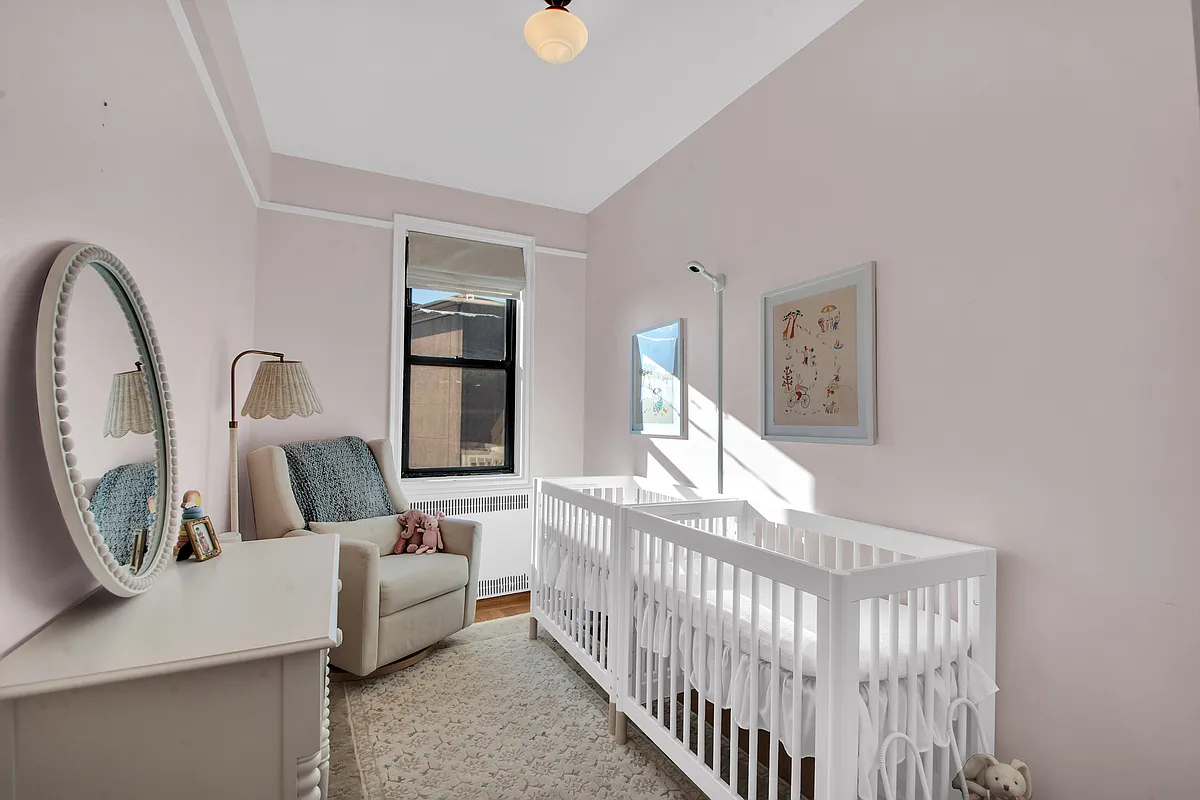 narrow bedroom set up as a nuersery