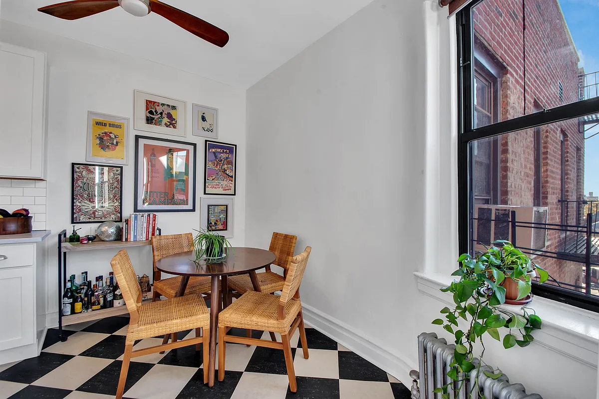 dining area in kitchen with checkerboard floor, ceiling fan