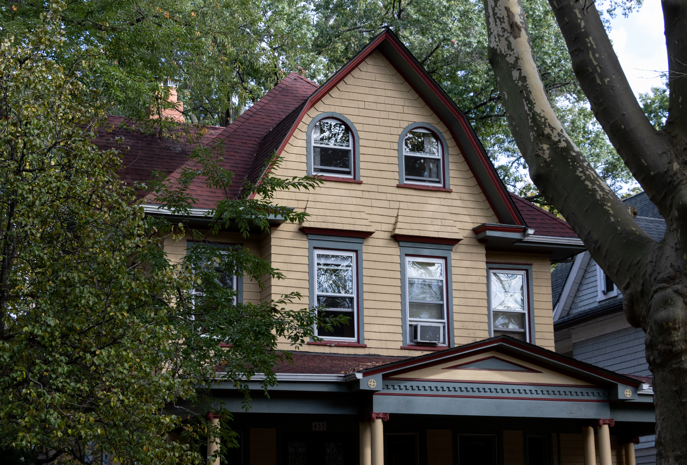 house with multi-colored trim and yellow siding