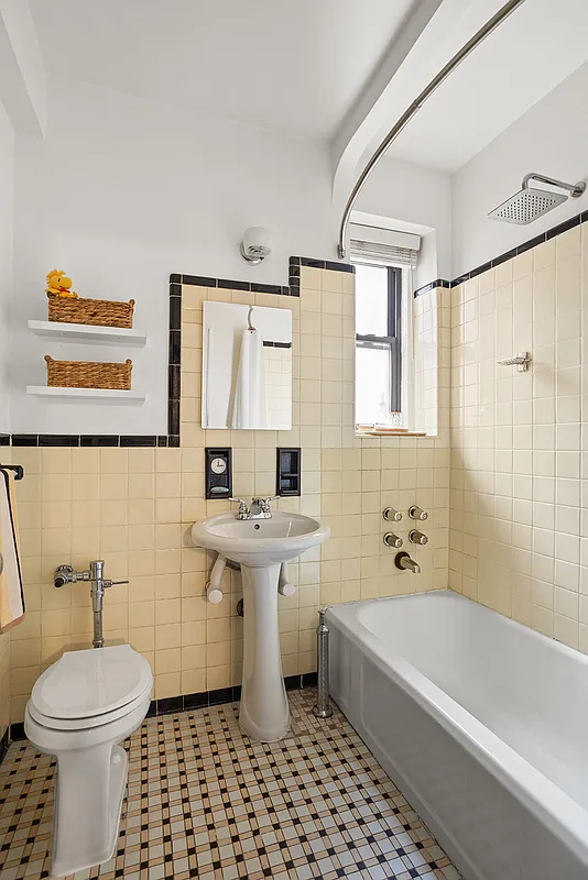 bathroom with yellow wall tile and white fixtures