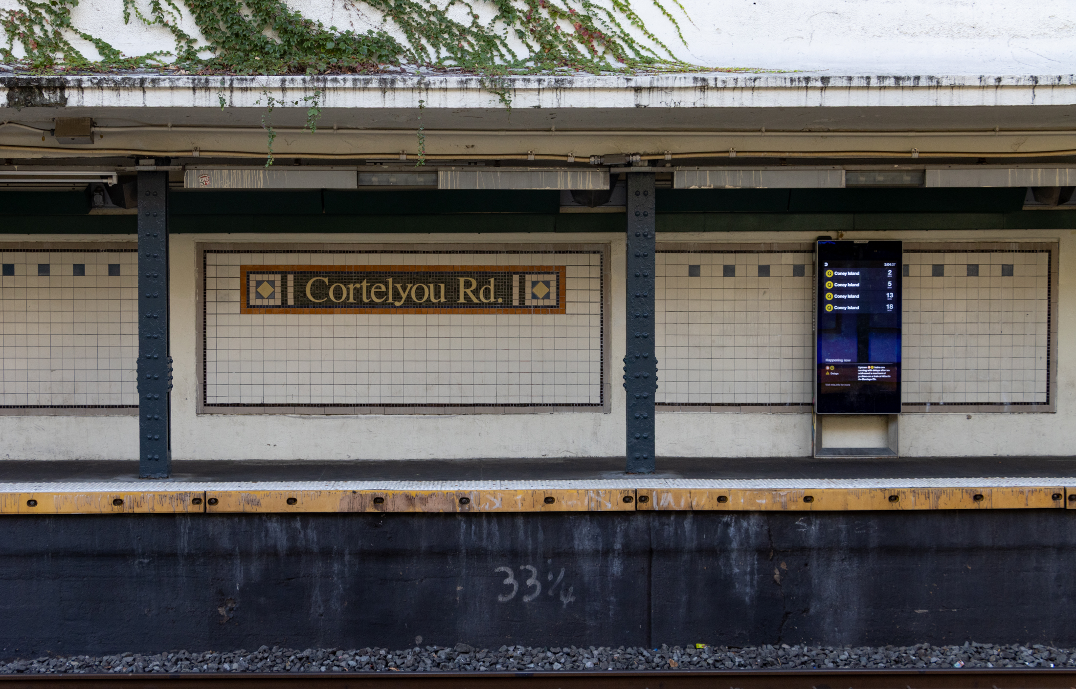subway platform with tilework spelling out Cortelyou Rd
