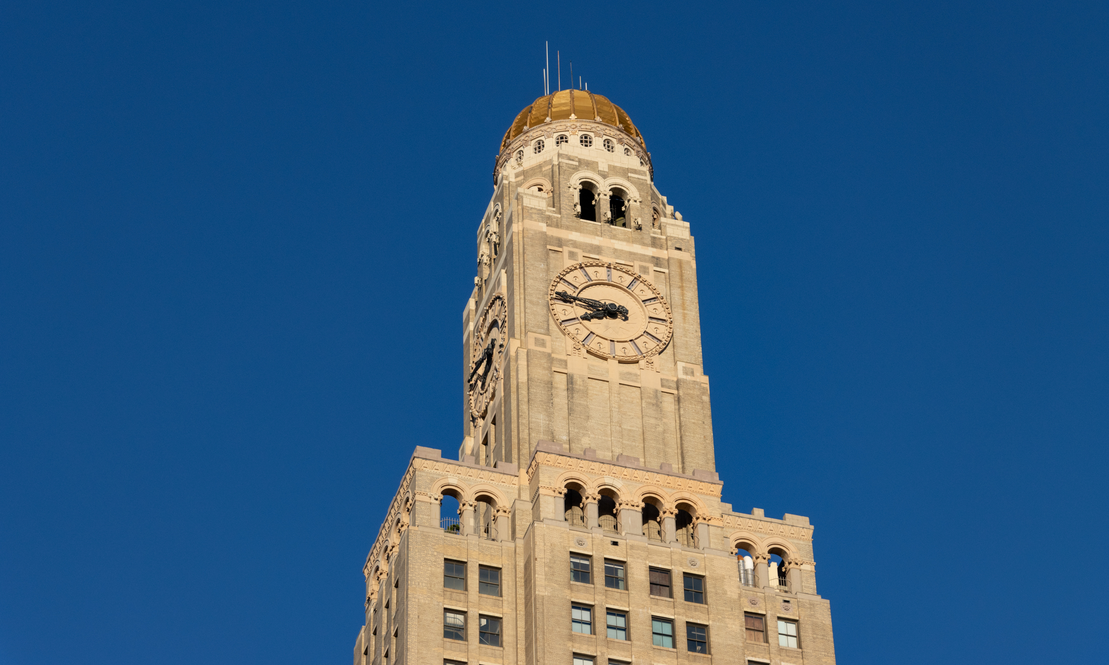 detail of the tower of the williamsburgh savings bank tower showing the giant clock and the gold dome