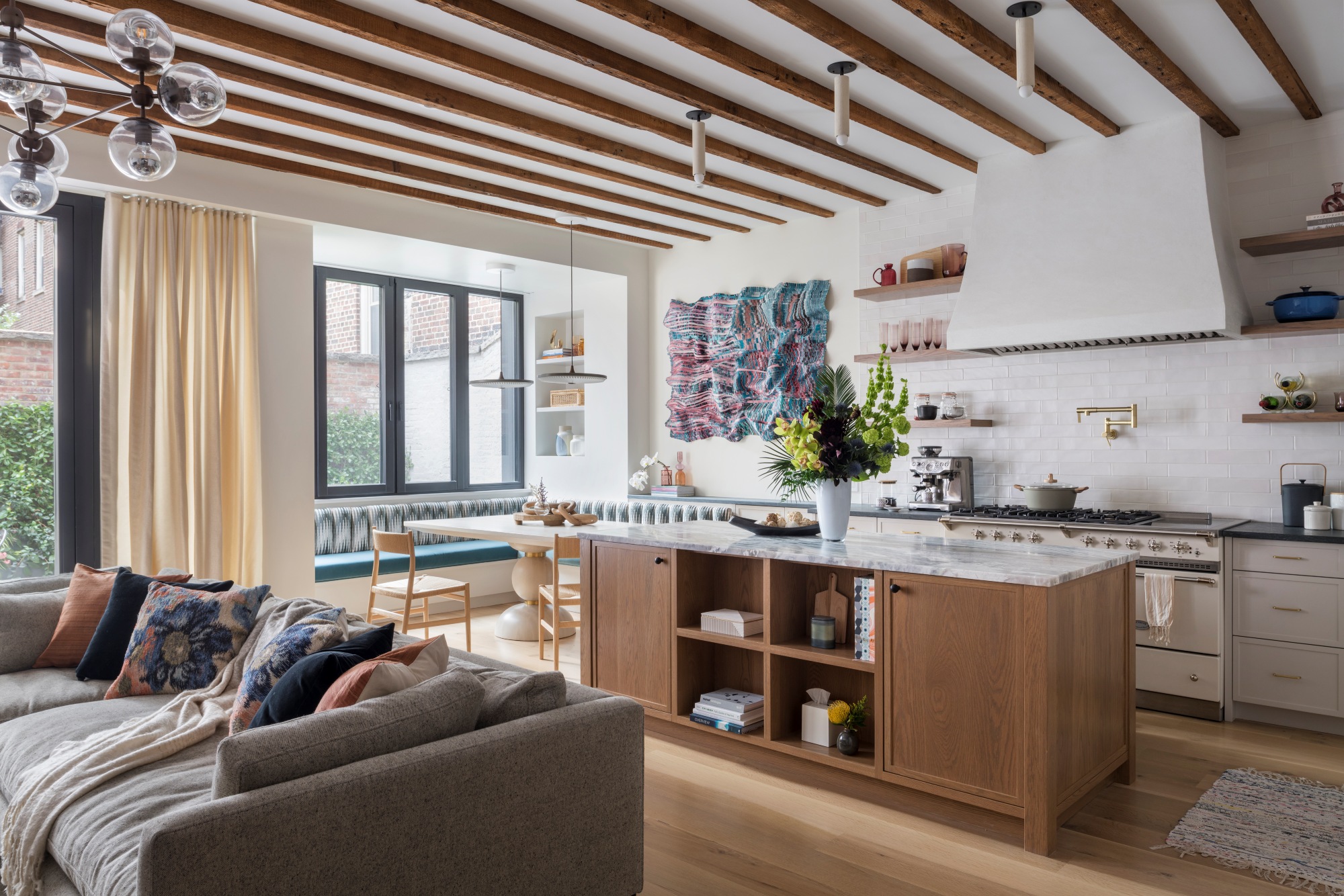 A great room in the former garage of a Brooklyn Heights carriage house, renovated by Ingui Architecture to Passive House standards, uses tilt and turn windows with extra layers of glass to eliminate drafts. 
