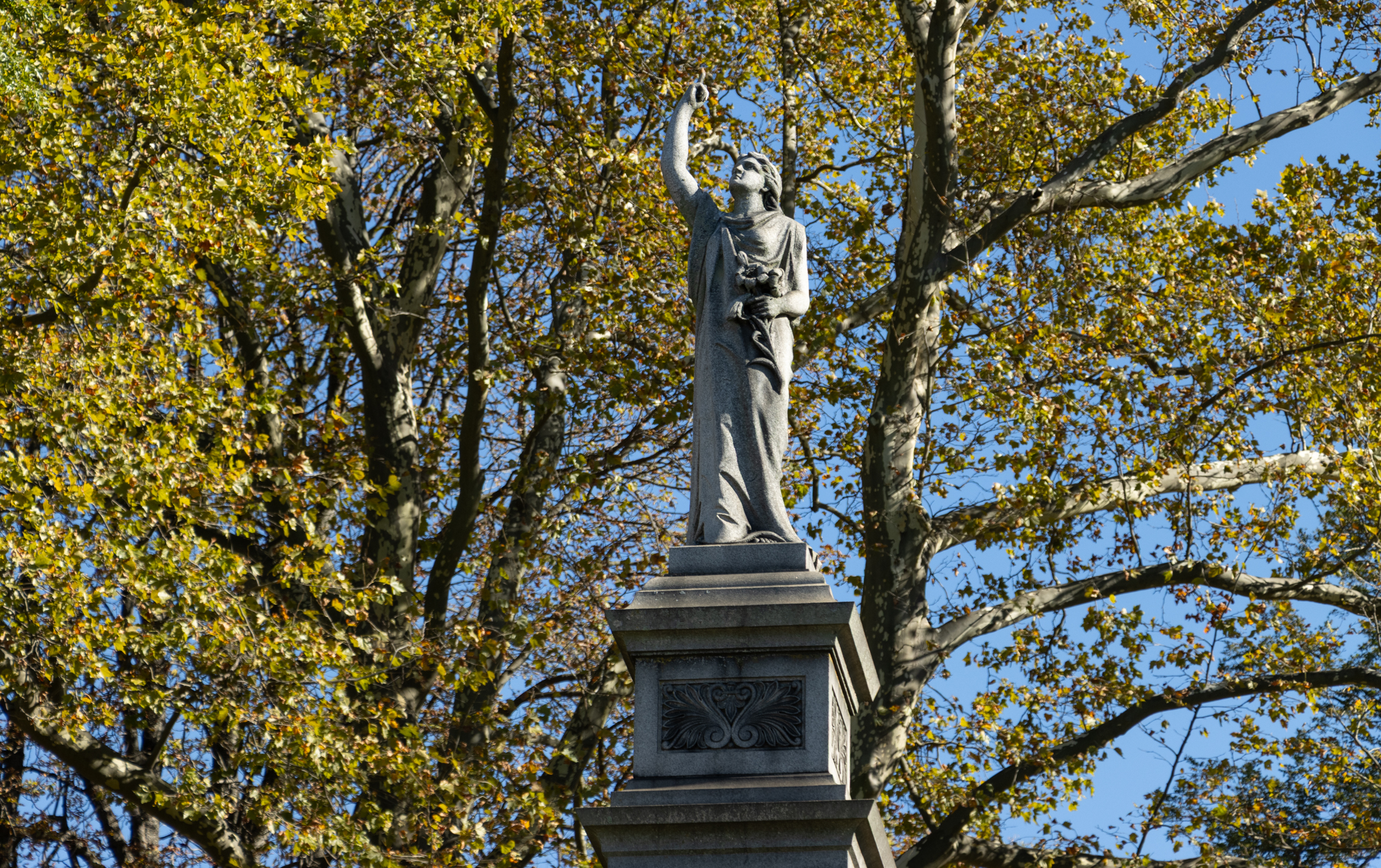 fall colors and a memorial sculpture