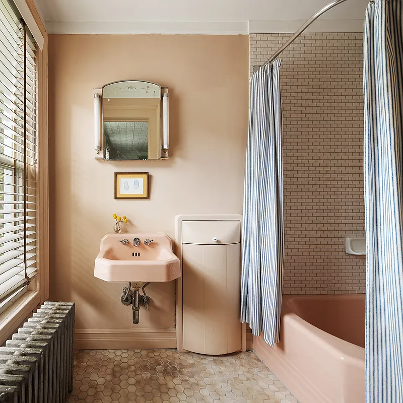 bathroom with pink sink and tub