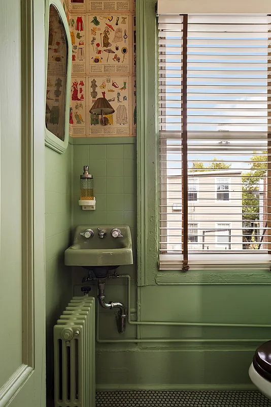 bathroom with green trim and a tiny green wall hung sink