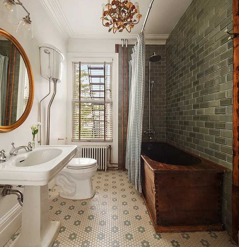 bathroom with wood tub, white pedestal sink, hex tile floor