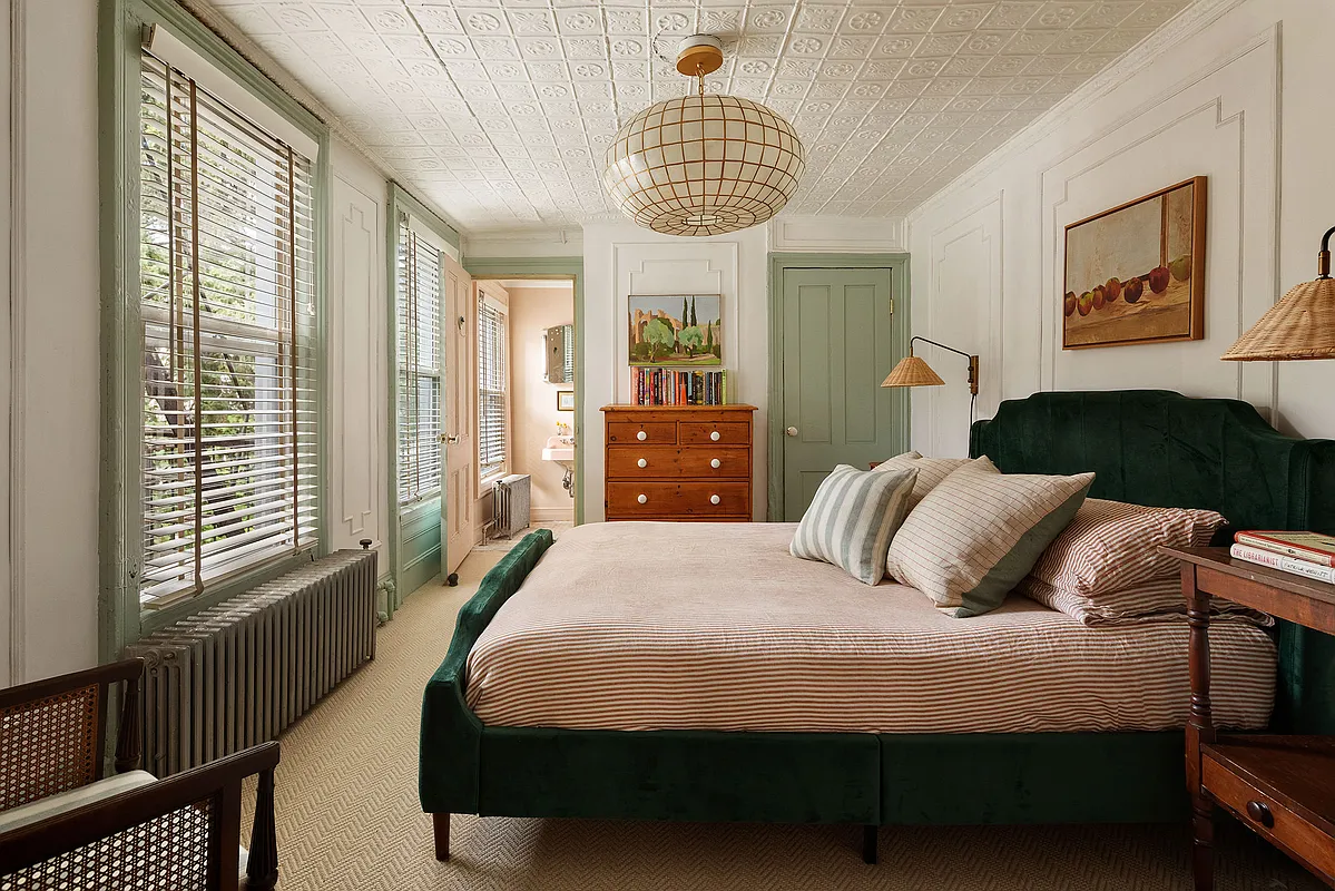 bedroom with tin ceiling, wall modlings, green trim
