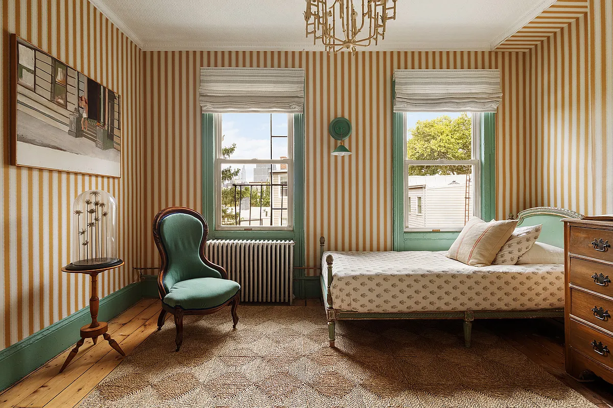 bedroom with gold striped wallpaper and green trim