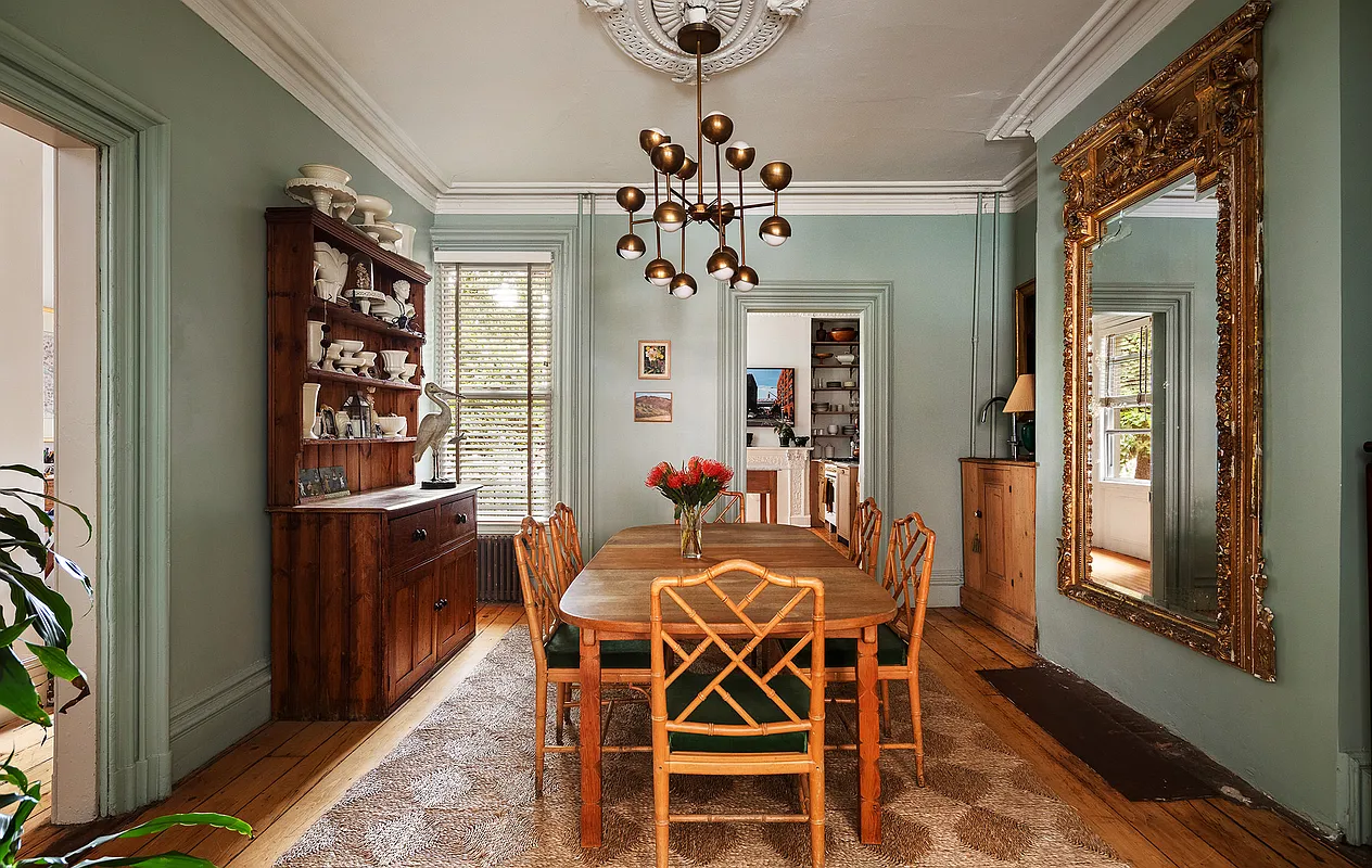 dining room with green walls, ceiling medallion, wood floor