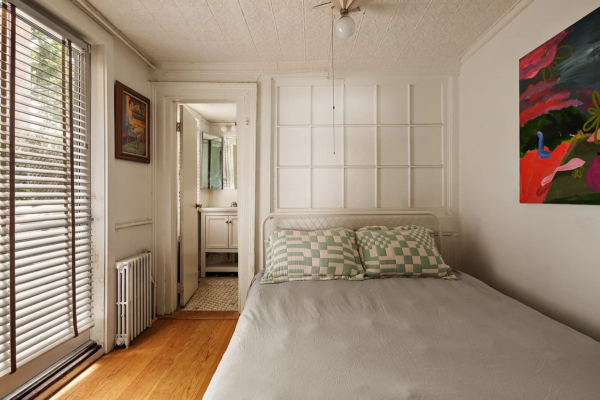 bedroom with tin ceiling, glass door to rear yard