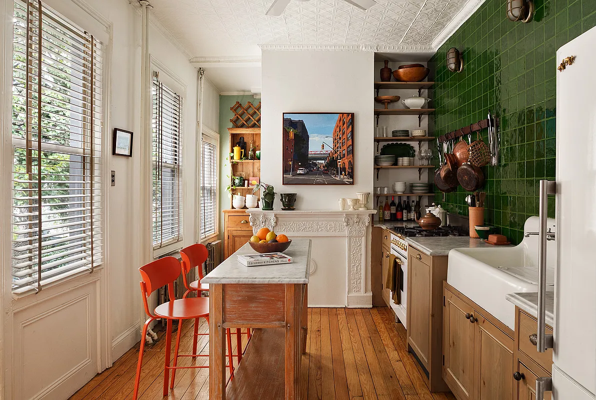 kitchen with green wall tile, vintage sink, tin ceiling