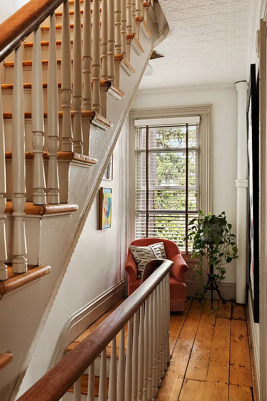 upstairs hall with tin ceiling and wide planked floor board