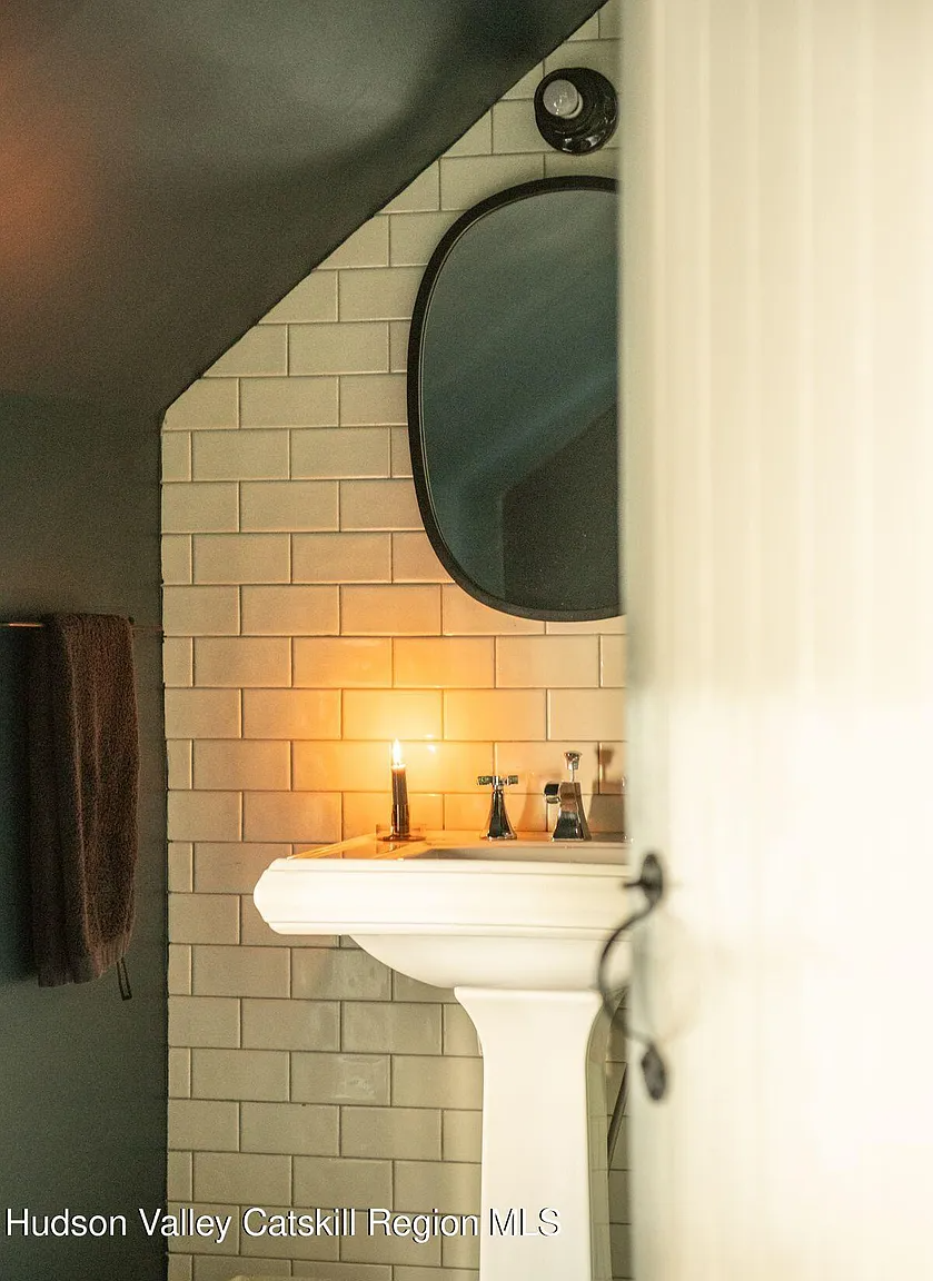 bathroom with subway tile on walls and a pedestal sink