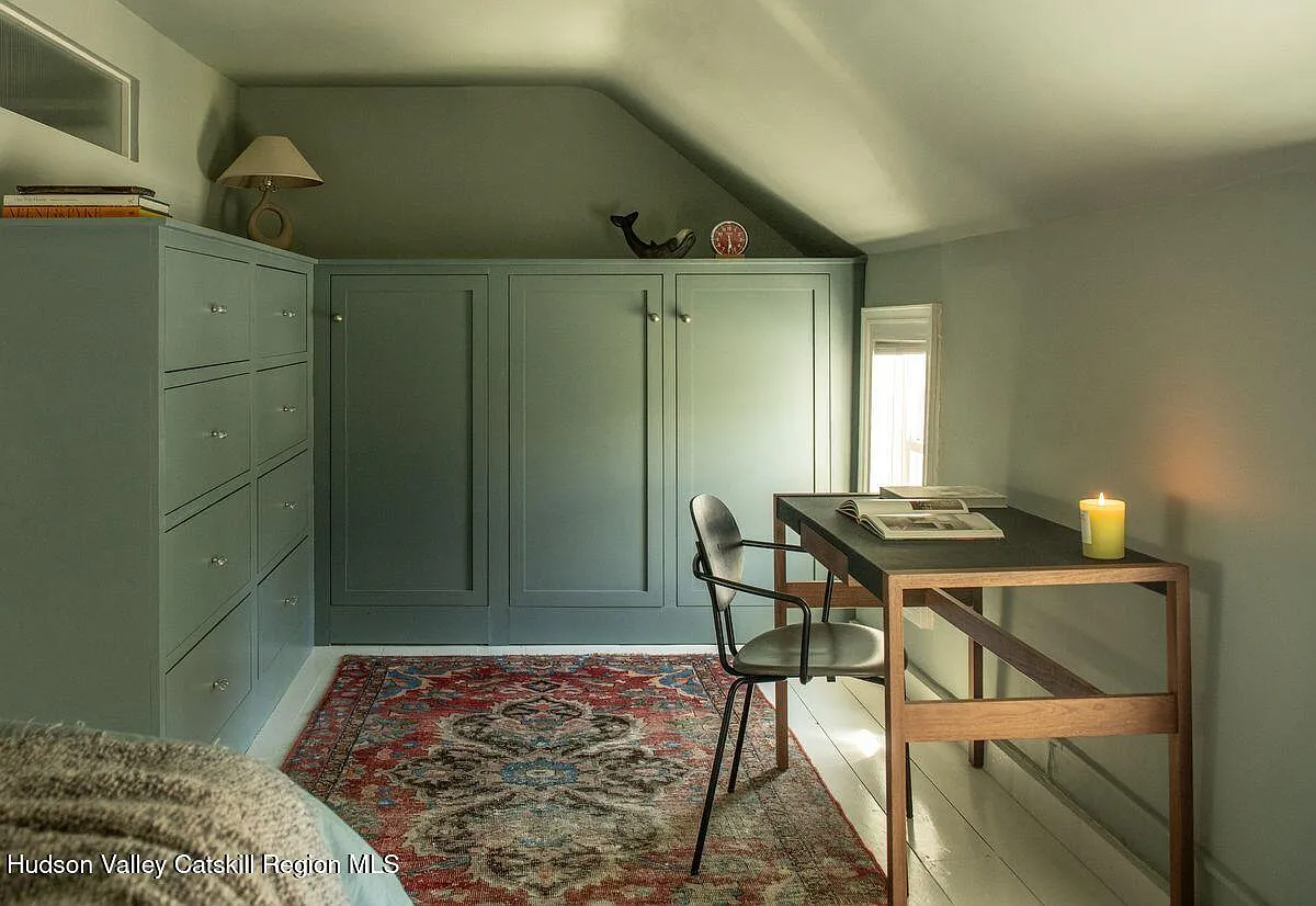 bedroom with corner of built-in storage painted blue