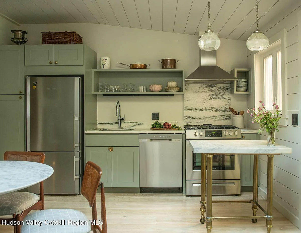 kitchen with pale blue cabinets, stainless steel appliances