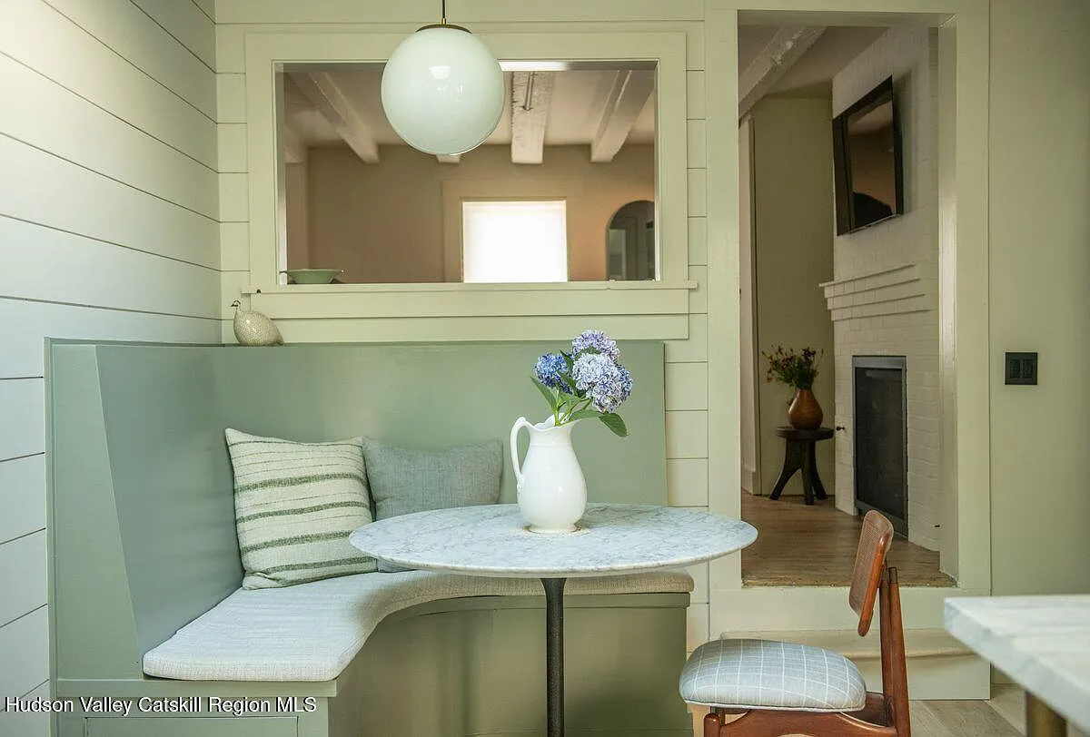 built-in corner banquette in the kitchen and a window passthrough to the living room