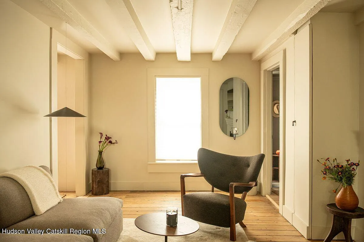 living room with walls and ceiling beams painted cream