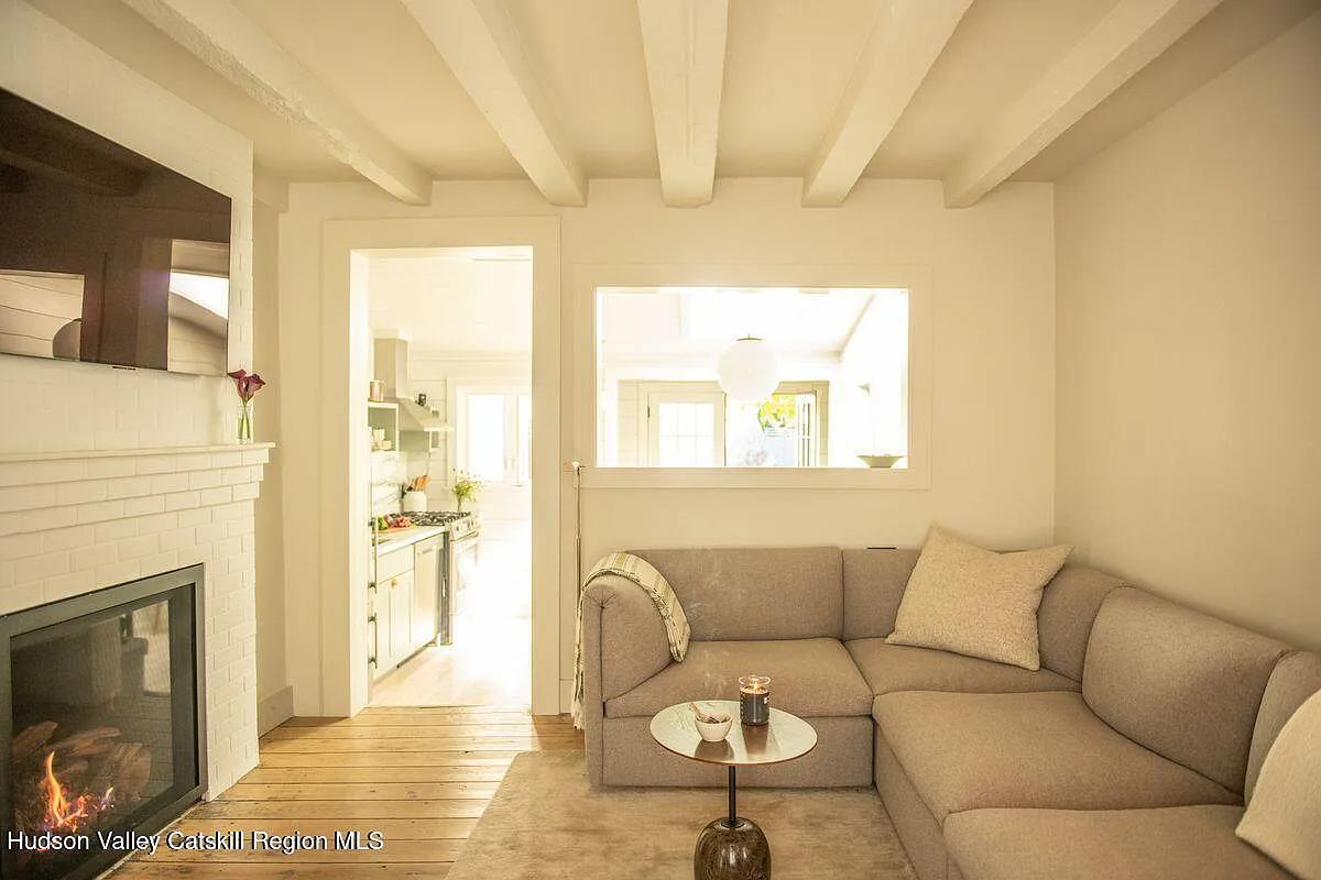 living room with a brick mantel painted cream