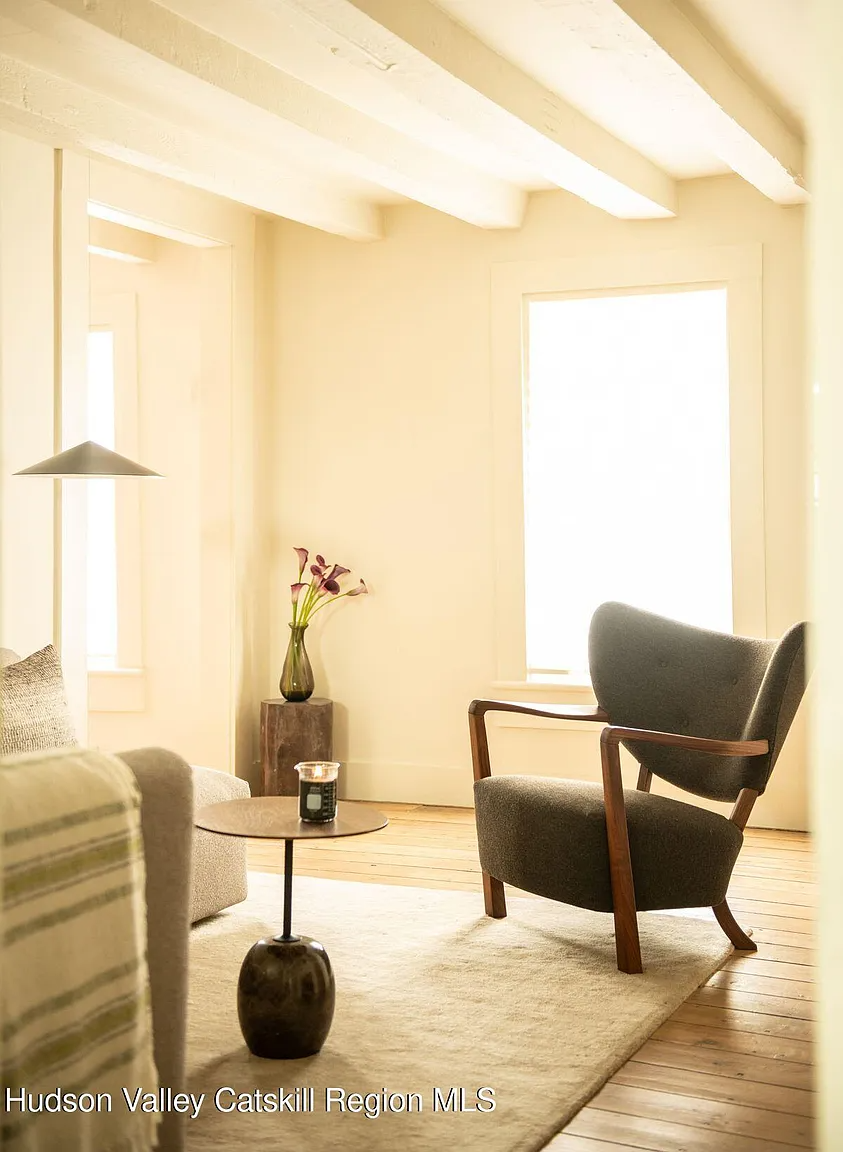 living room with walls and ceiling beams painted cream