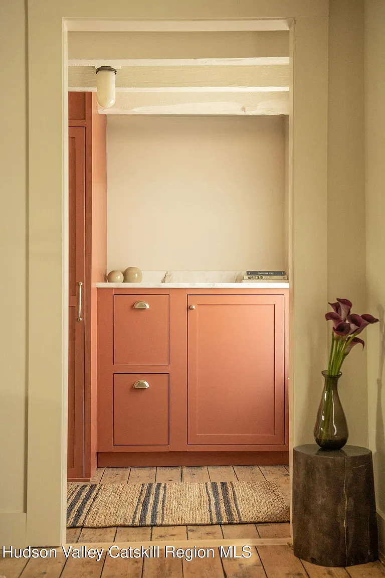 built-in storage painted terra cotta and with bin pull hardwood