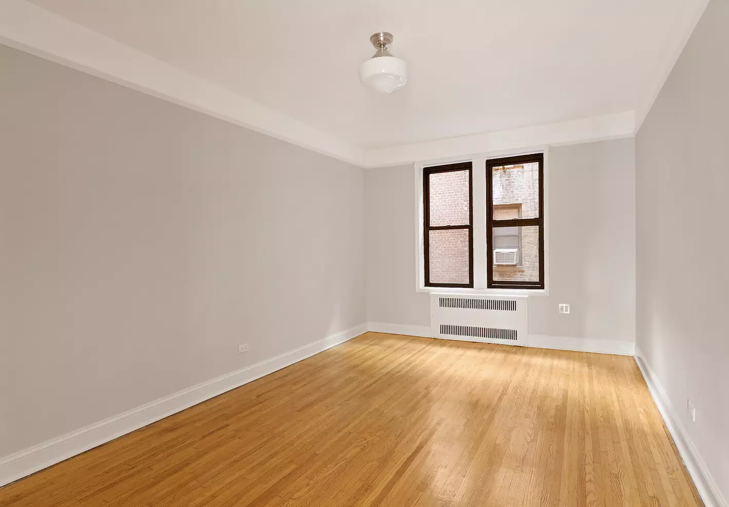 bedroom with picture rail, wood floor