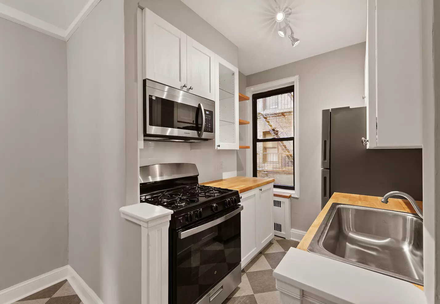 kitchen with white cabinets, butcher block countertops