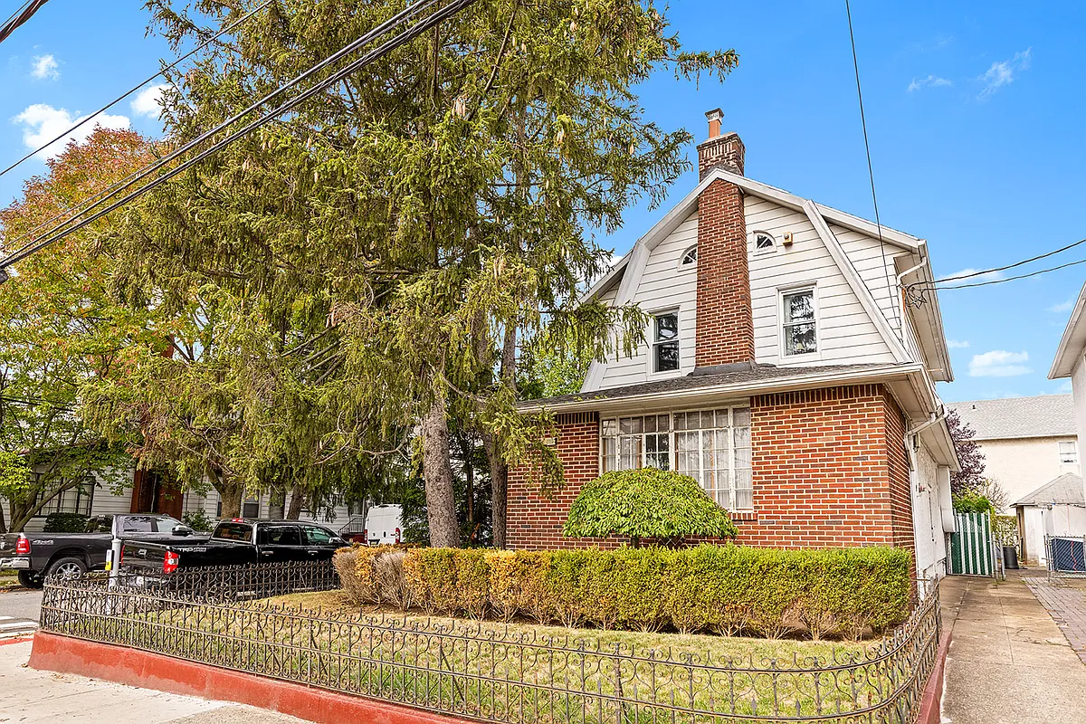 house with gambrel roof and a brick chimney
