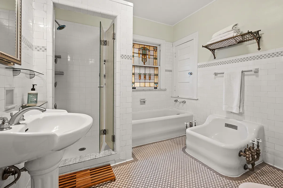 bathroom with built-in shower, vintage tub