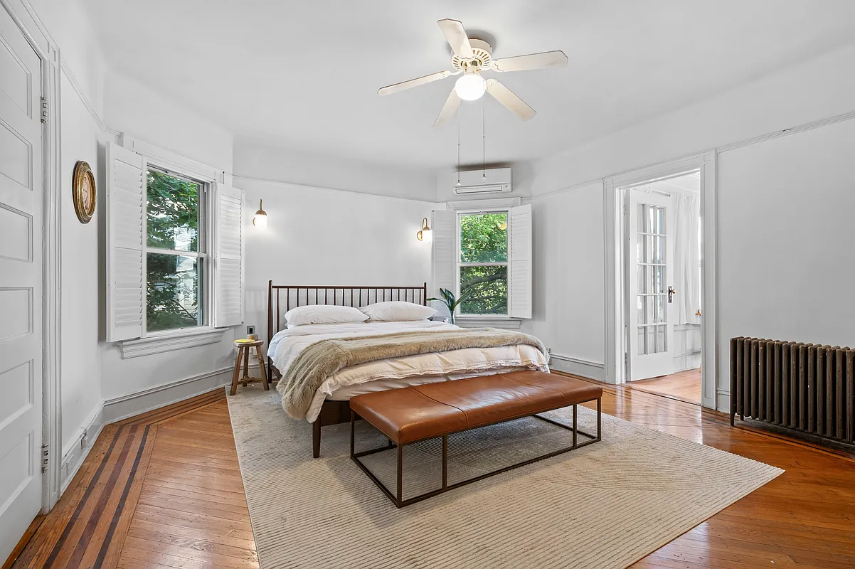 bedroom with white walls, ceiling fan
