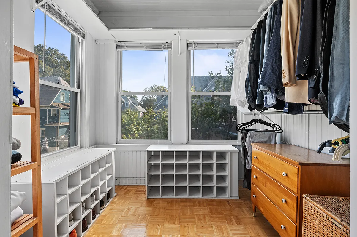 portion of sleeping porch set up as a walk-in closet
