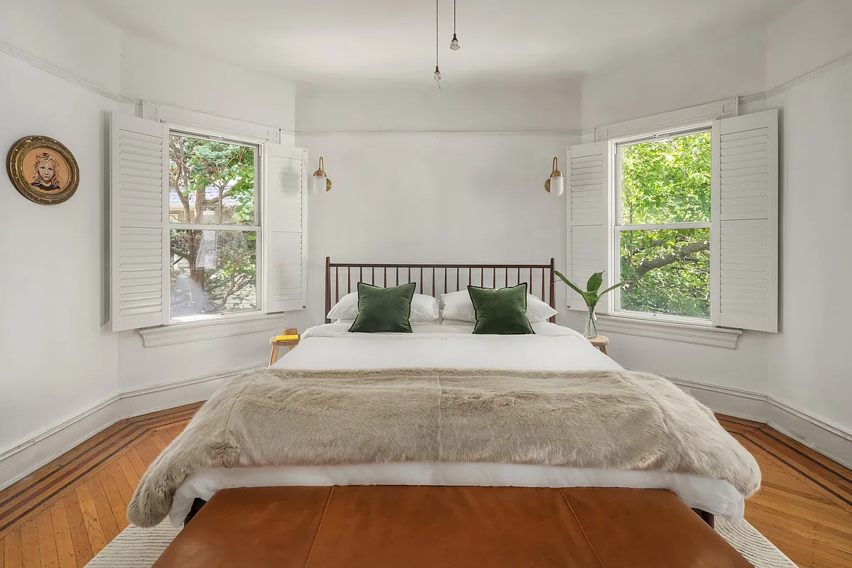 bedroom with white walls, picture rail, wood floor