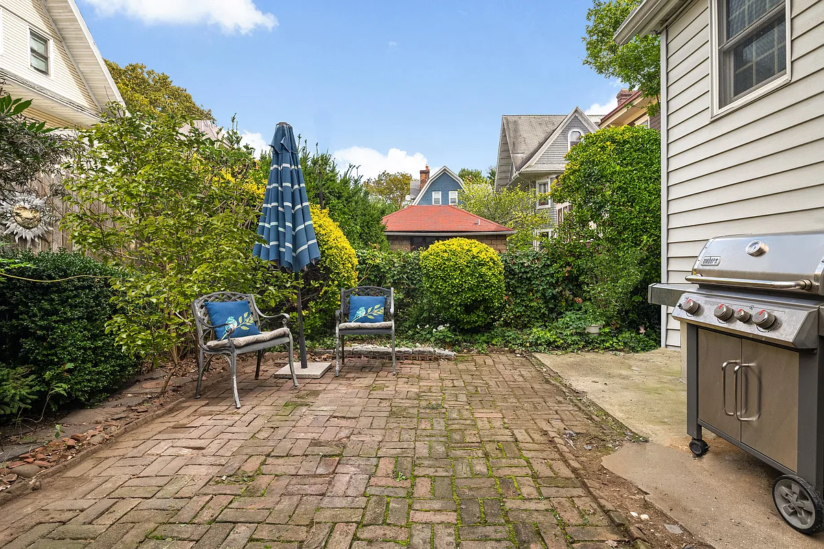 brick paved patio with concrete pad for grill