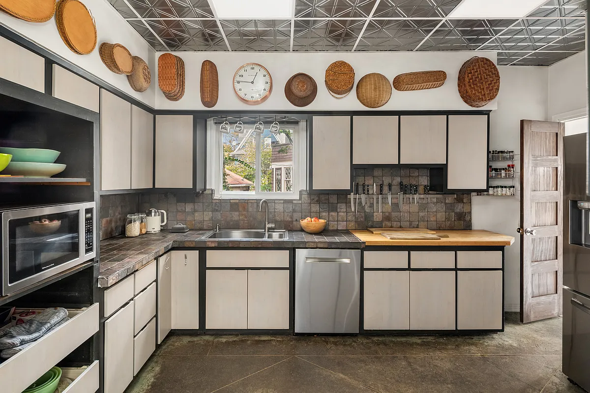 kitchen with concrete floor, white cabinets