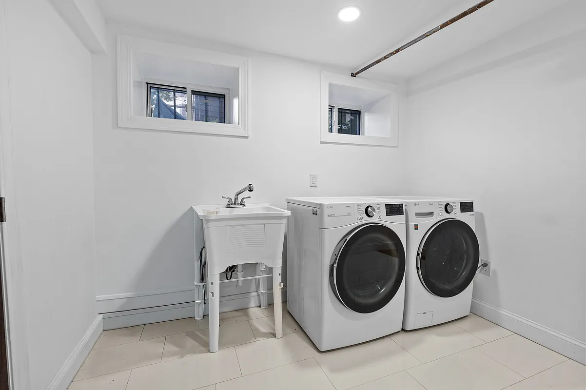 laundry room with tile floor, utility sink