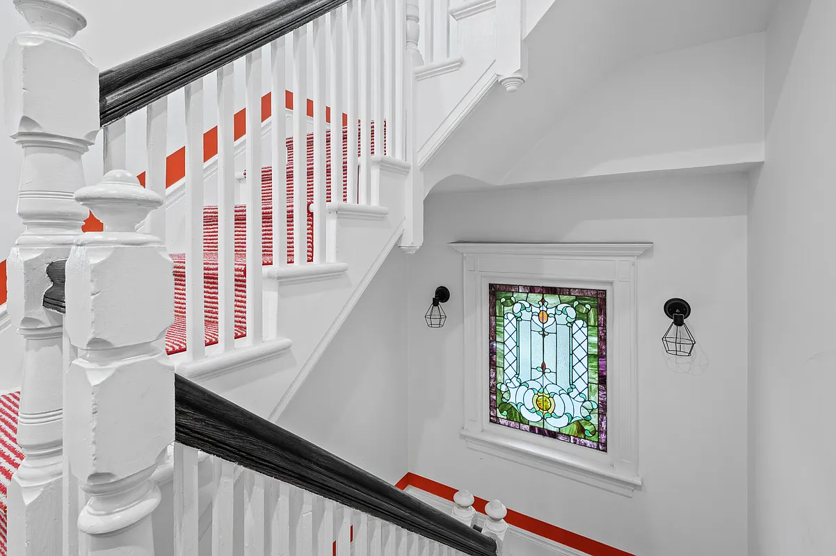 stair hall with a stained glass window