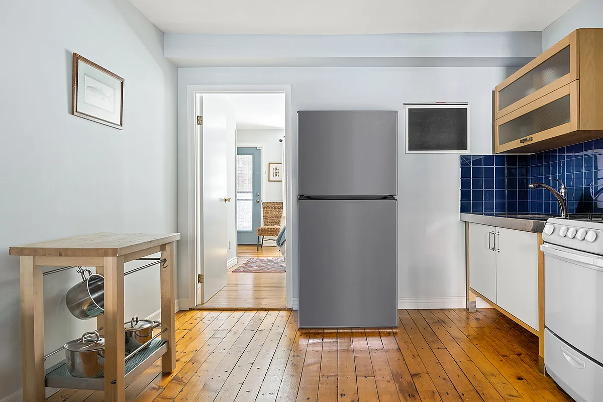 kitchen with blue tile backsplash, wood floor