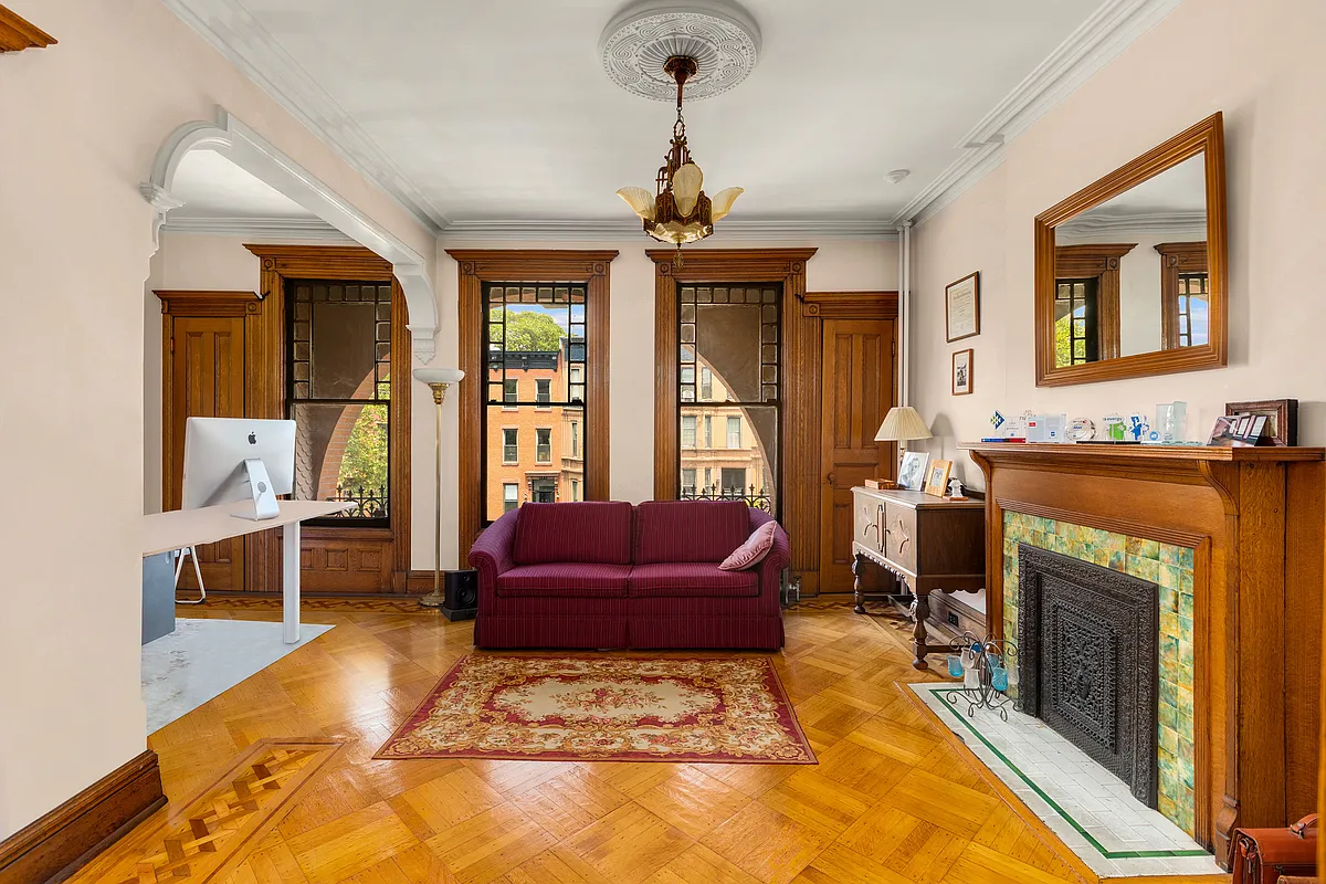 bedroom with a mantel and access to a terrace set up as a den and office